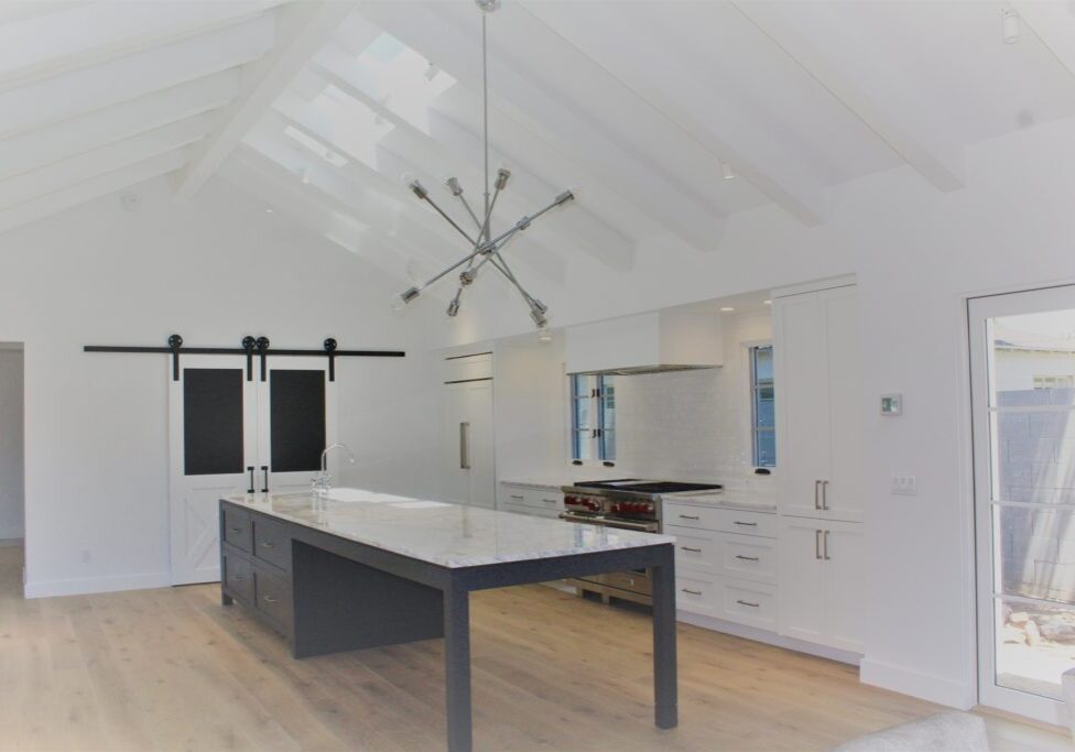 Kitchen AFTER - Custom white cabinets, gourmet appliances and eat in island are a perfect space for this family. 